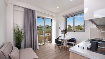 Deluxe Suite, 1 King Bed with Sofa bed | Living area | 40-inch flat-screen TV with satellite channels