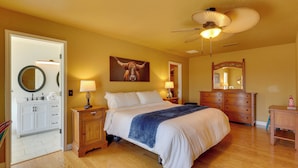 A bedroom with a bed, bedside tables, a ceiling fan, a mirror, and a dresser. - Furnished Patio, Grill & Views: Lake Havasu Home (Lake Havasu City)