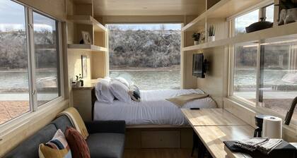Tiny home with one queen bed on main floor and full size futon.