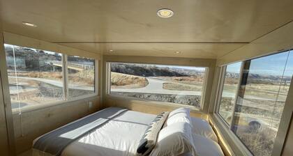 XL tiny home with two lofted queen beds and full size futon on the main level.