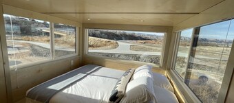 XL tiny home with two lofted queen beds and full size futon on the main level.