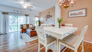 A dining area with a white table and chairs, a chandelier, and a ceiling fan. - 4 Mi to Disney: Emerald Island Resort Home! (Kissimmee)