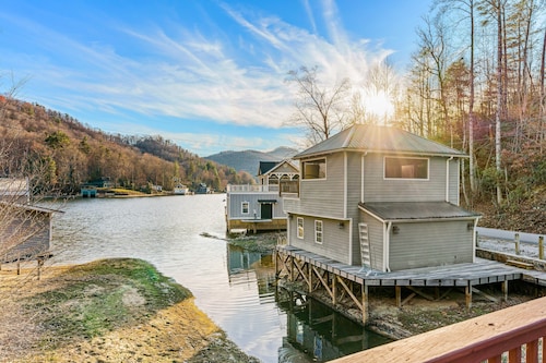 Rustic two-story lakefront cabin near beach with dock, lake & mtn views, & deck