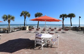 Enjoy a relaxing meal or drink on the beachfront patio, surrounded by palm trees and the soothing sound of the ocean.