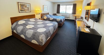 Stay in comfort in this room featuring two queen beds, a private bathroom, sitting area, mini fridge, and single-serve coffee maker. Guests also have access to a microwave in the lobby. Perfect for couples, friends, or families looking for a cozy and