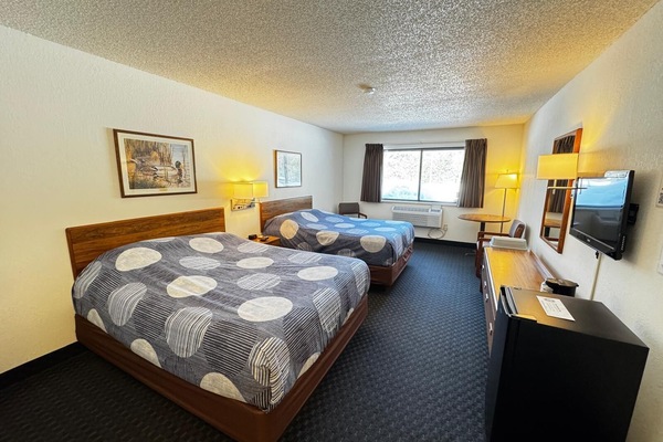 Our 2 Queen room includes a mini fridge and single-serve coffee maker. For a dog stay in Rooms 115, 117, 119, 120, or the Northwoods Getaway, you must call the lodge directly to book. Human-only stays may book online.