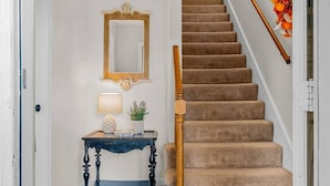 A staircase with carpeted steps and a wooden handrail. - Family Friendly with Kid activities (Tifton)