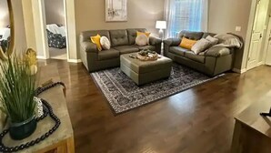 A spacious living room with a sectional sofa, a coffee table, and a ceiling fan. - A Peaceful Family Friendly Home in Sarasota Fla, Legacy Trail/Pinecraft (Sarasota)