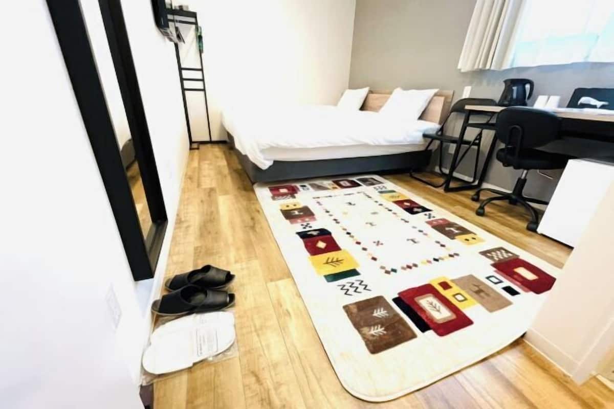 Premium bedding, desk, laptop workspace, soundproofing