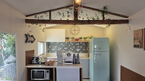 A compact kitchen with a microwave, coffee maker, and a vintage-style refrigerator. - Rose Inn (Seoul)