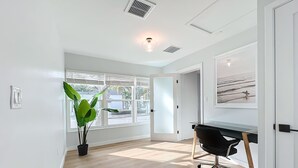 A spacious room with a large window, a desk, and a potted plant. - Gorgeous Downtown Sarasota, Historic Laurel Park Home. (Sarasota)