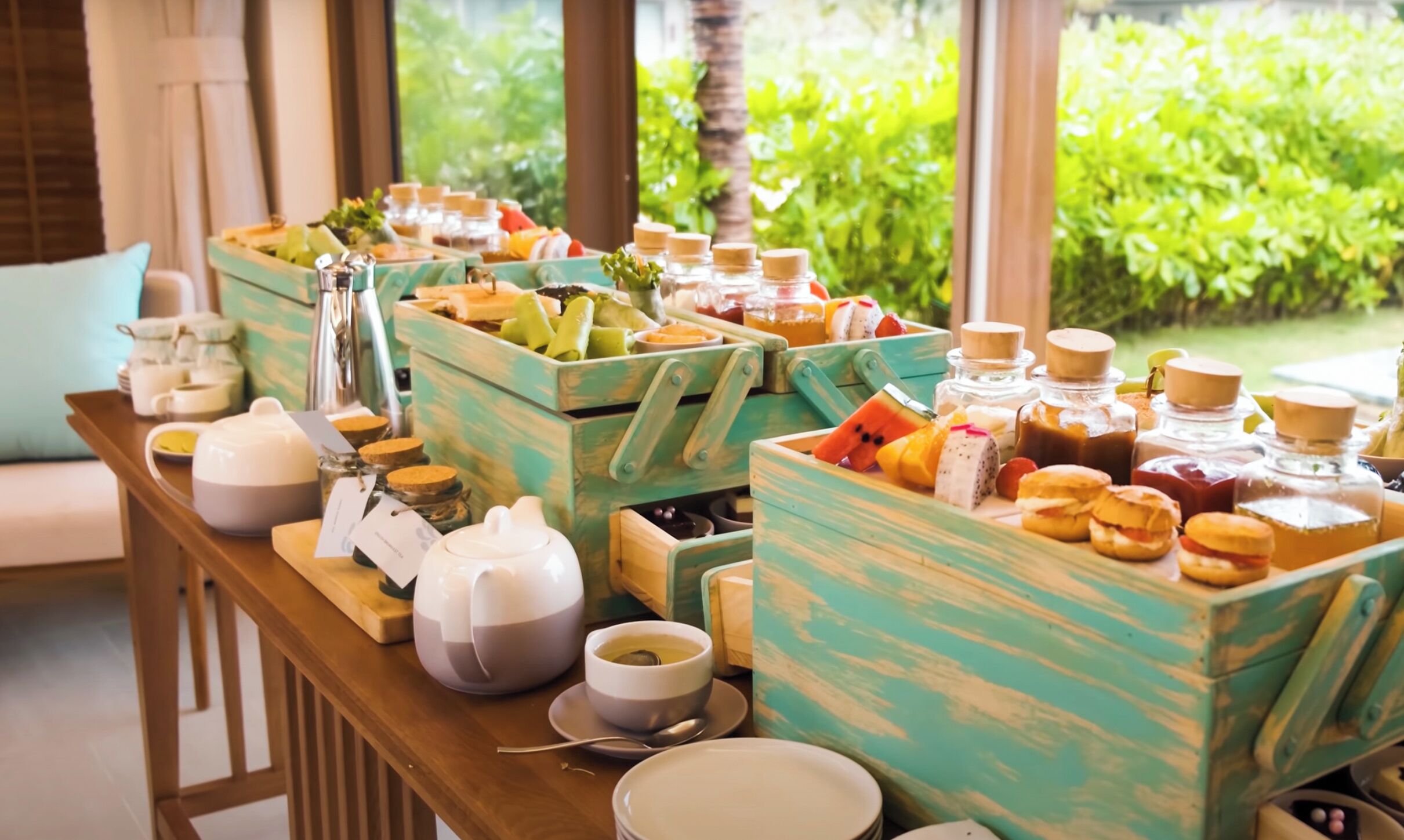 A breakfast buffet with various food items and beverages in wooden crates.