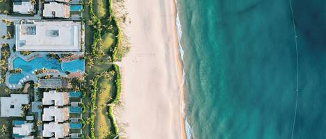 On the beach, white sand, sun loungers, beach umbrellas