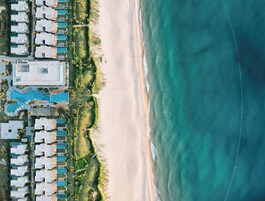 On the beach, white sand, sun loungers, beach umbrellas
