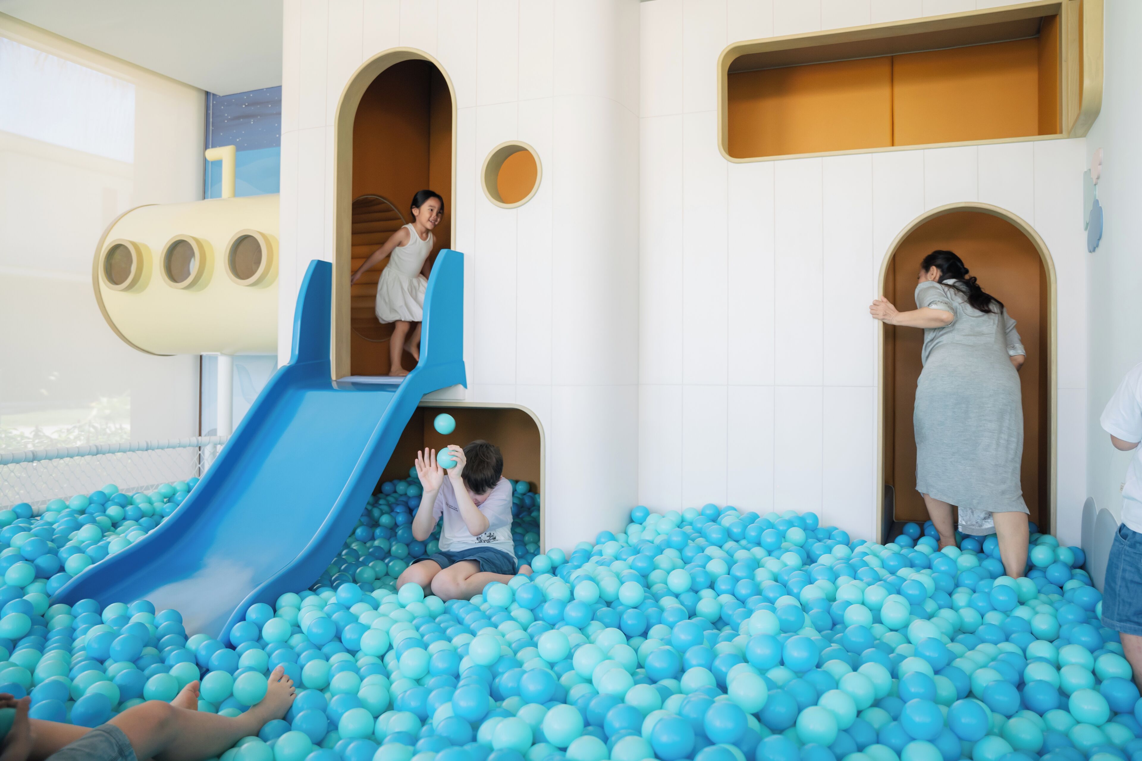 A play area with a slide and ball pit.