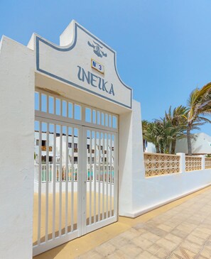 A gated entrance with a sign reading 'INEIKA' and a number 'N3' above it.