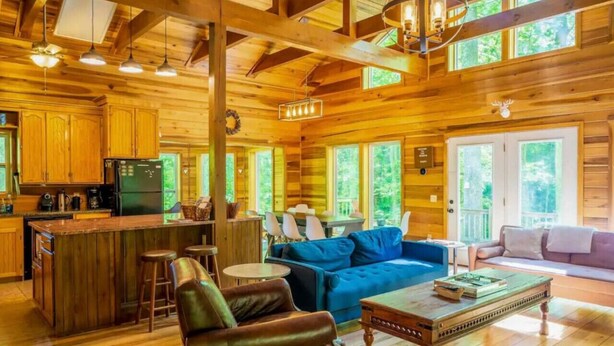 A cabin interior with a kitchen, dining area, and living room. - 🔥 Fall Flash Sale –15% Off Waterfall deal Spacious 3 Bedroom Cabin Plus One Bedroom Beekeeper Cabin Waterfalls AWD or 4WD recommended (Hot Springs)