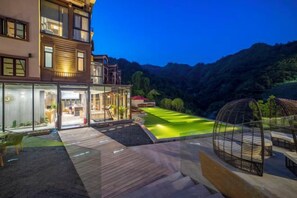 Un bâtiment moderne à deux étages, doté d’une entrée bien éclairée et d’un jardin aménagé.