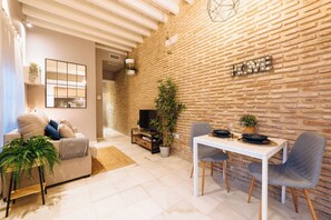 Relax in a cozy space with a comfortable seating area, dining table, and entertainment options.