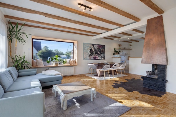 A modern living room with a sofa, coffee table, and fireplace.