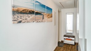 A hallway with a wooden floor, a white wall, and a door. - Holiday Apartment "4" with Mountain View, Shared Garden & Wi-Fi (Wallhausen)