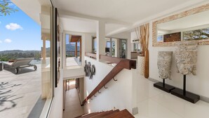 A modern interior with a staircase, a pool area, and a view of the outdoors. - Samui Summit villa (Koh Samui)