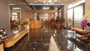 A spacious lobby with a polished marble floor, a grand chandelier, and a reception desk. - Cat Tuong Hotel (Lam Vien - Da Lat)