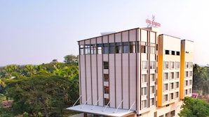 A modern building with a sign reading "UVA MANISH". - UVA MANISH (Kundapur)