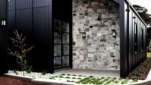 A modern building with a stone facade, a dark exterior, and a clear sky. - Luxury Villas Flinders Retreat (With Car Parking) (Flinders)