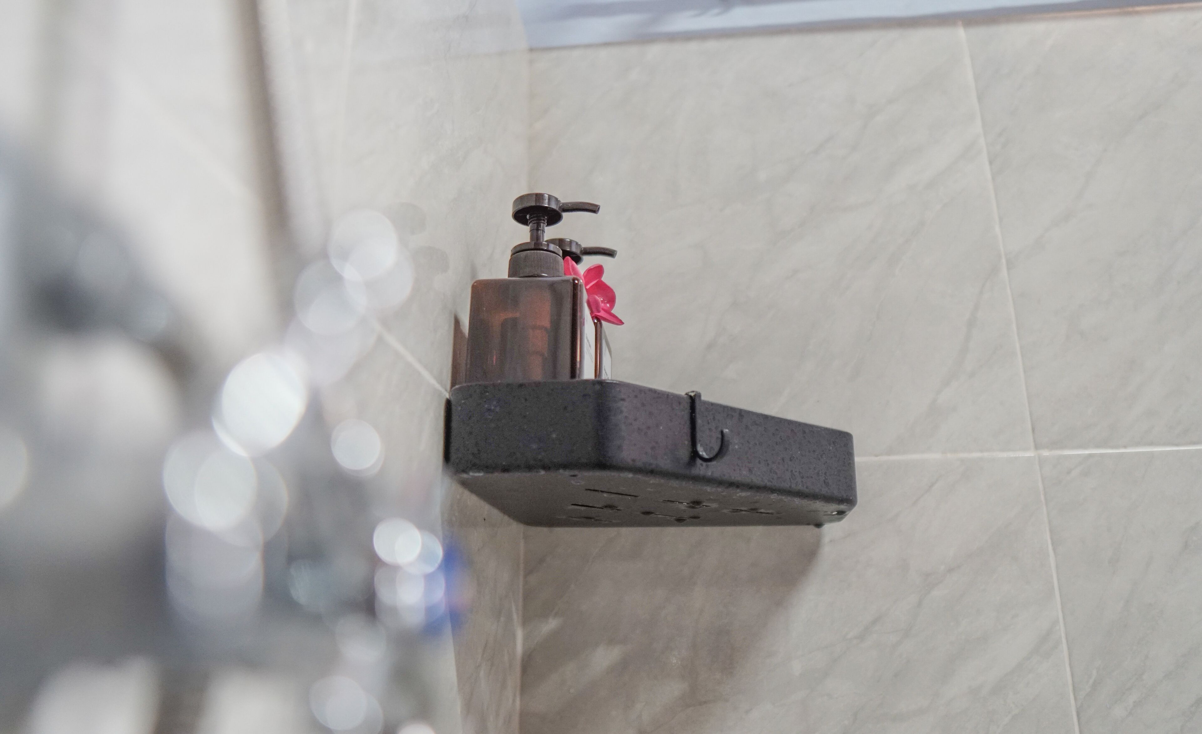A bathroom with a mounted sink and a towel rack.