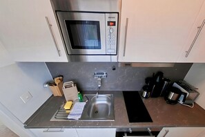 Fridge, microwave, stovetop, coffee/tea maker