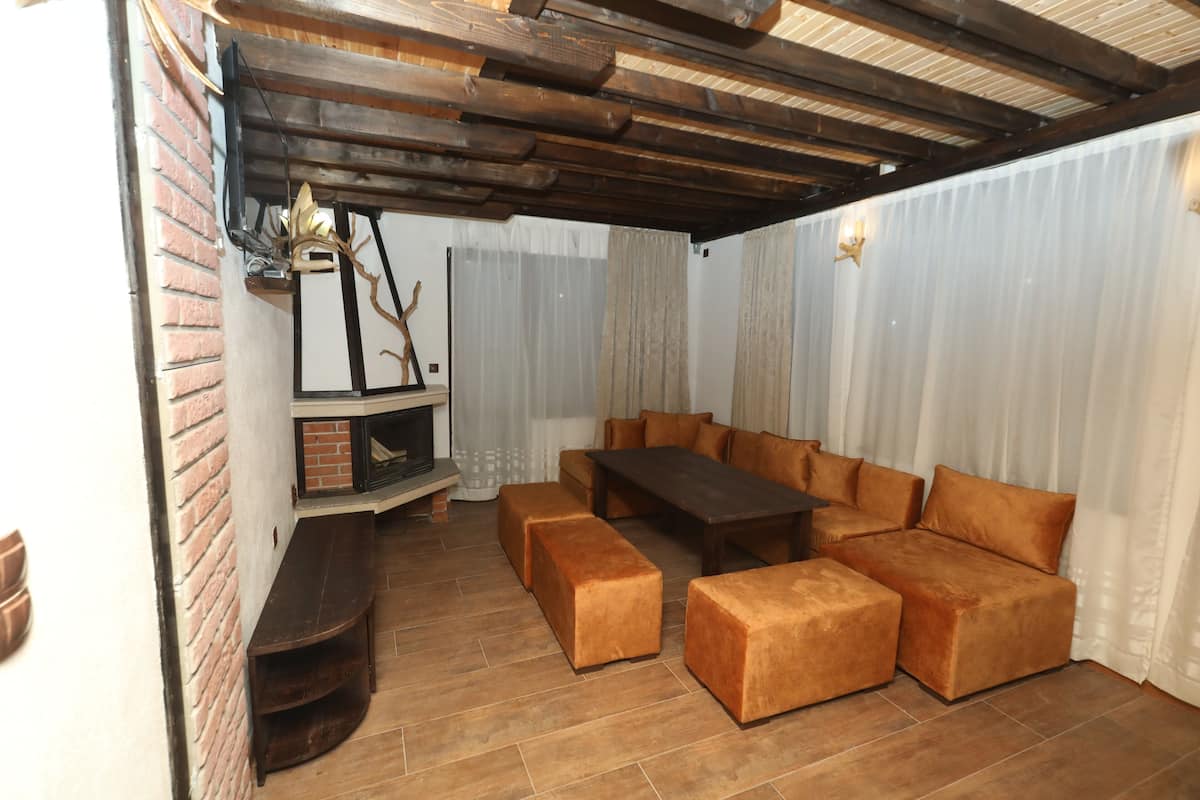 A cozy living area with a wooden bench, a sofa, and a coffee table.