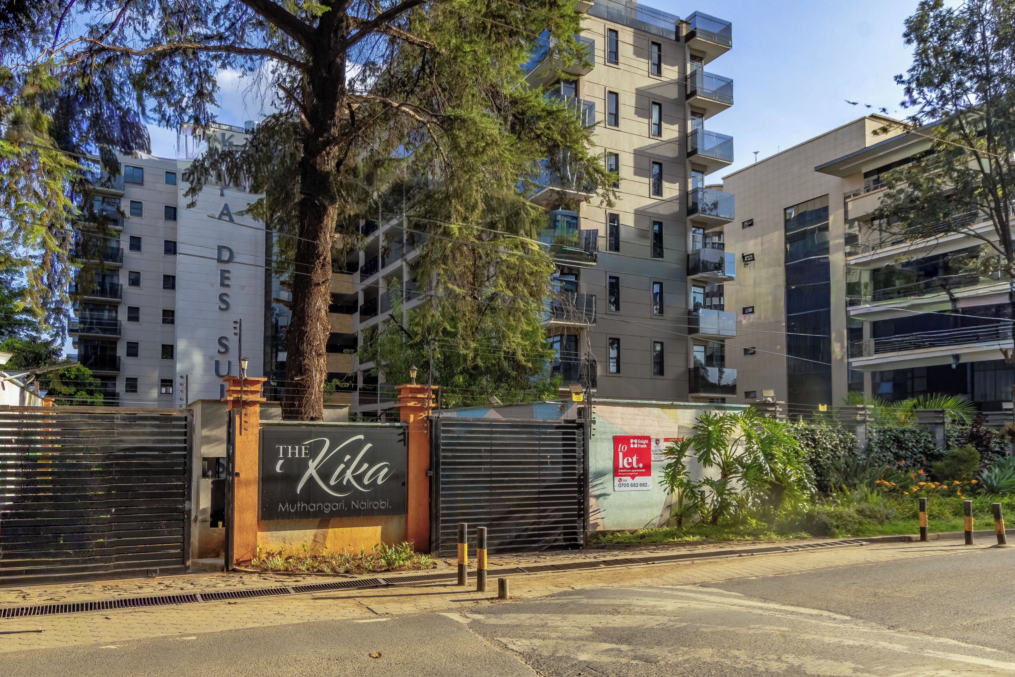 A gated entrance with a sign for 'The Kika Muthangari, Nairobi.'