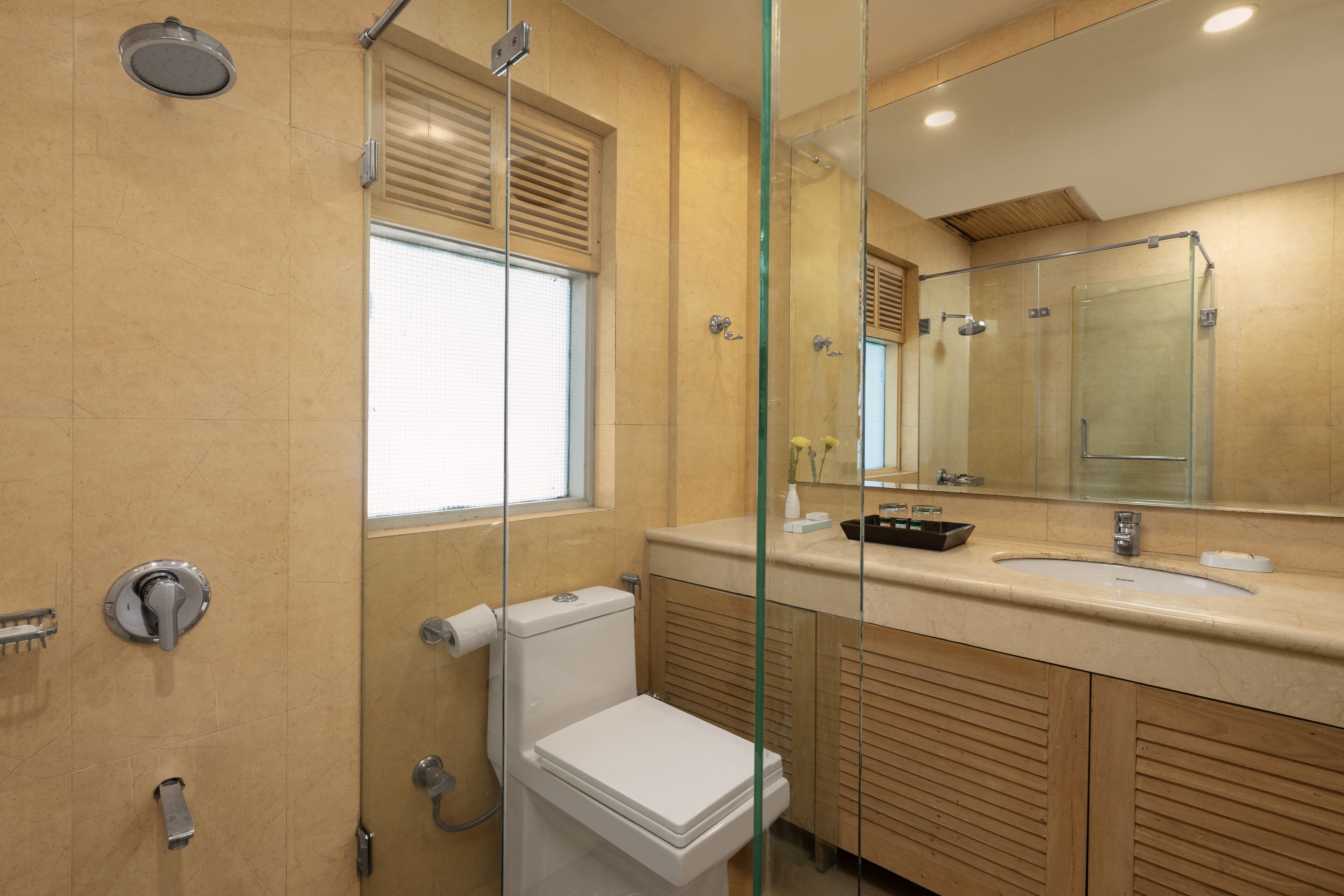 A modern bathroom with a toilet, bidet, and shower.