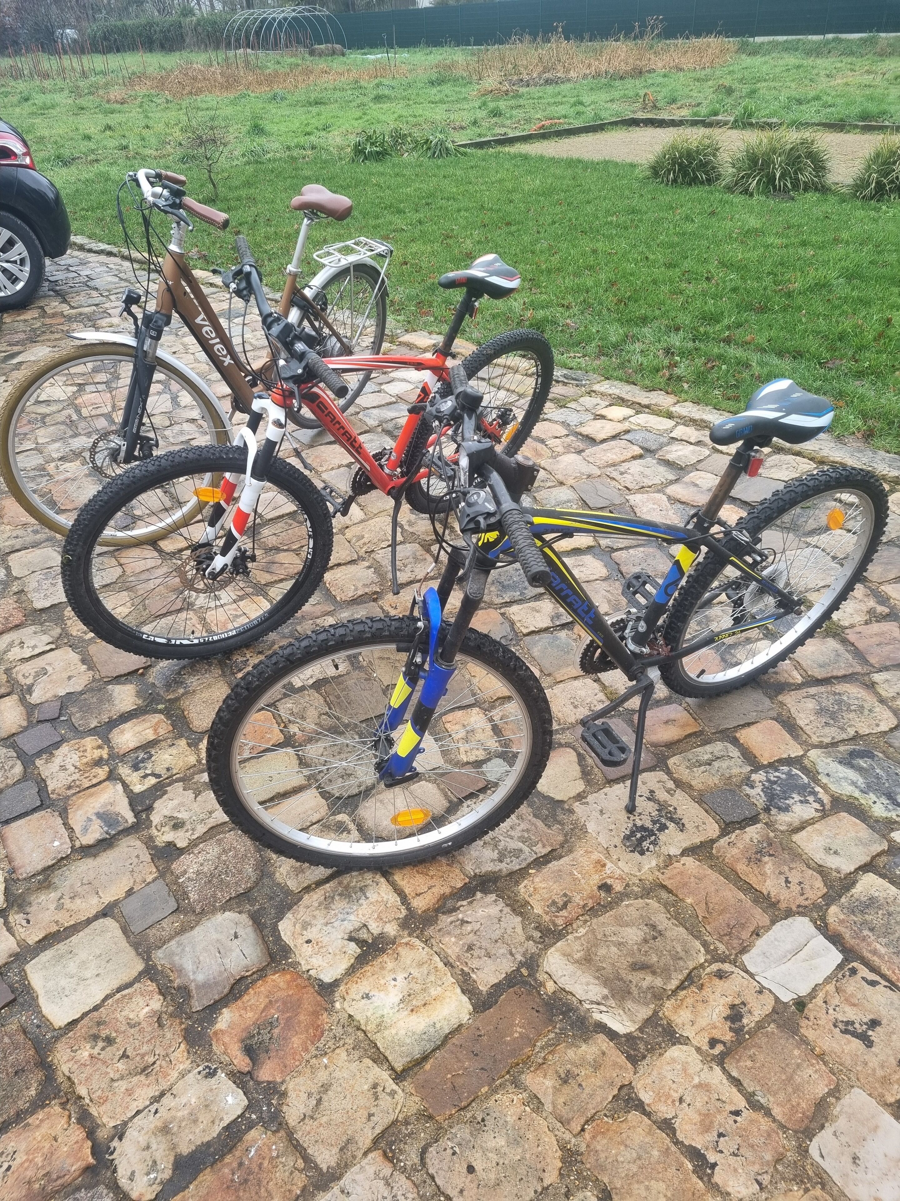 A stone-paved area with bicycles parked.