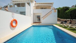 A swimming pool with a lifebuoy, a staircase, and a door leading to an upper level. - Villa Ocean Breeze - Steps away from the Beach (San Jaime Mediterráneo)
