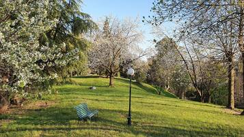 A park with a bench, trees, and a lamp post.