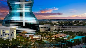 A modern building with a unique guitar-shaped design, surrounded by a lush landscape and a clear sky. - Young Circle & Hollywood Blvd ~ Posh Studio Suite (Hollywood)