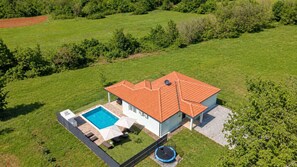A house with a swimming pool, a trampoline, and a fenced yard. - Villa Petar by Villas Guide (Buroli)