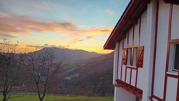 Une maison avec vue sur une vallée et des montagnes.