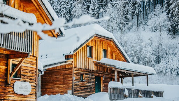 A wooden cabin with a snow-covered roof and a sign that reads "Chalet Necrant." - Woody 12 - with sauna & 2 cozy terraces (St. Georgen am Kreischberg)
