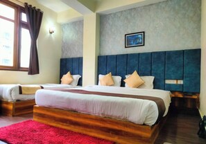A hotel room with two beds, a red rug, a grey textured wall, and a framed picture. - Aurora Gangtok (Gangtok)
