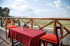 Enjoy al fresco dining on the deck overlooking the scenic landscape.