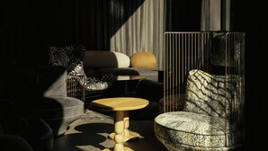 A modern living room with a sofa, a patterned armchair, a small wooden table, and a metal cage structure. - The Cloud One Gdansk (Gdansk)