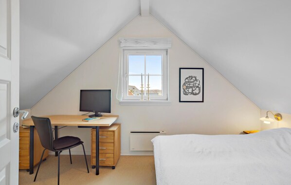 A small, triangular attic bedroom with a desk, chair, and bed. - Beautiful home in Brenderup Fyn (Brenderup Fyn)