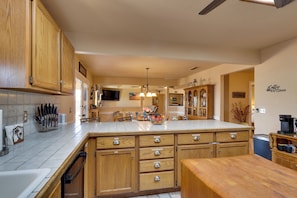 A kitchen with wooden cabinets, a large island, and a coffee bar. - Furnished Patio, Grill & Views: Lake Havasu Home (Lake Havasu City)
