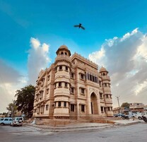 A historic building with intricate architecture, a central dome, and a courtyard.