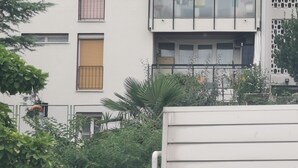 A modern building with multiple windows and balconies, surrounded by dense greenery. - Apartment Budin 2 Rijeka City Center (Rijeka)