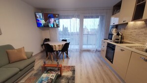 A modern living room with a sofa, coffee table, and a TV mounted on the wall. - Apartment Budin 2 Rijeka City Center (Rijeka)