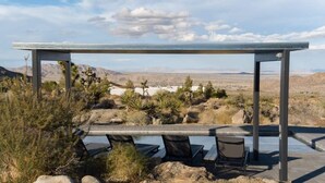 A pool area with a pergola, chairs, and a view of a desert landscape. - Sunset Heights By Homestead Modern (Joshua Tree)